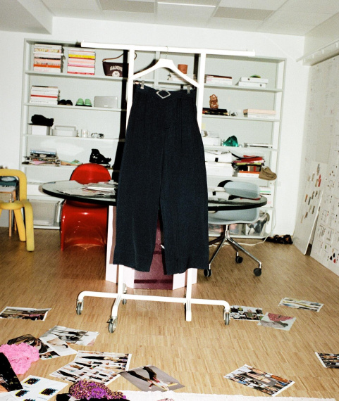 navy pants made with recycled circulose® material hanging in a room filled with vintage accessories and polaroids